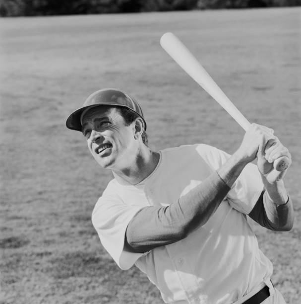 Baseball player swinging baseball bat  archival stock pictures, royalty-free photos & images