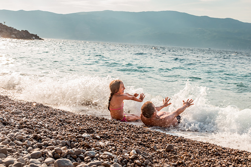 Cheerful Father and Daughter on Summer Holiday Enjoy Splashing in the Sea and Playing with  Waves, Mediterranean Sea, Croatia