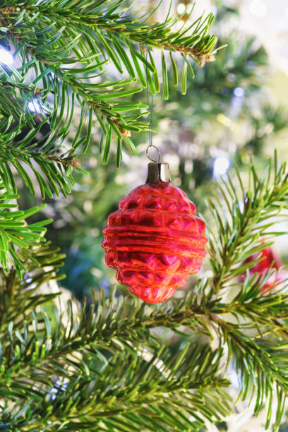 istock Red multi-faceted flashlight-new years Soviet glass Christmas tree toy on a branch 1204275846