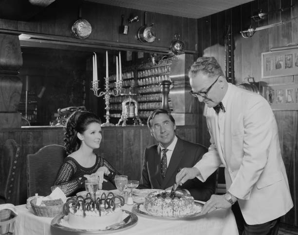 Waiter serving cake to couple at table  waiter photos stock pictures, royalty-free photos & images