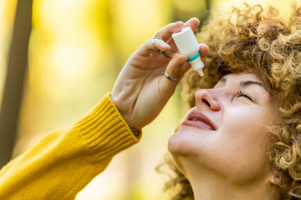 istock Young woman putting eye drops 1204276259