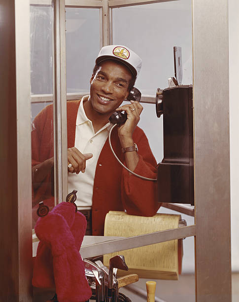 Man inside telephone booth talking on phone  1968 stock pictures, royalty-free photos & images