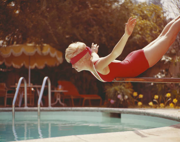 Young woman with blindfold balancing on diving board  1969 stock pictures, royalty-free photos & images