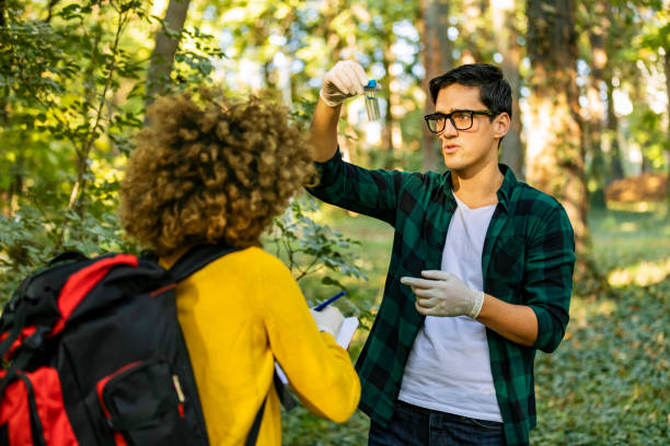 istock Two scientists exploring water in lake. Scientists study water in the forest 1204277291