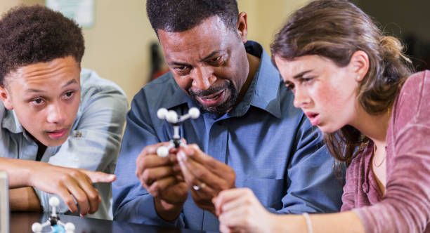 istock Teacher and students in chemistry class 1204277313