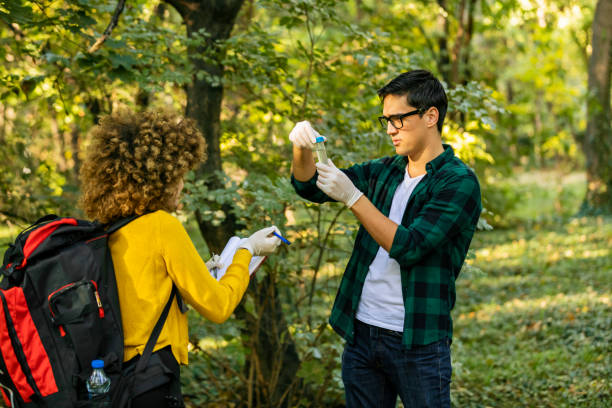 istock Two scientists exploring water in lake. Scientists study water in the forest 1204277434
