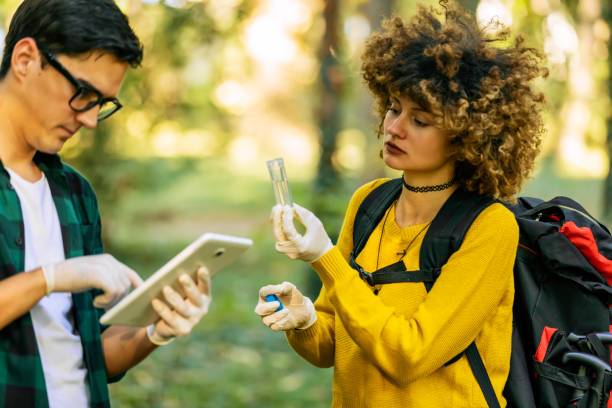 istock Two scientists exploring water in lake. Scientists study water in the forest 1204277616