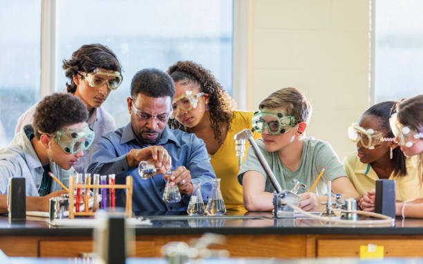 istock Multi-ethnic teacher and students in chemistry lab 1204277654