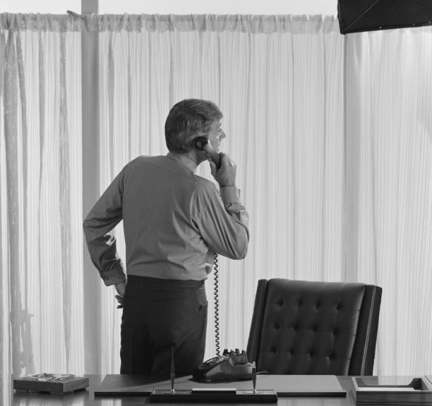 Businessman using telephone in office  1971 stock pictures, royalty-free photos & images