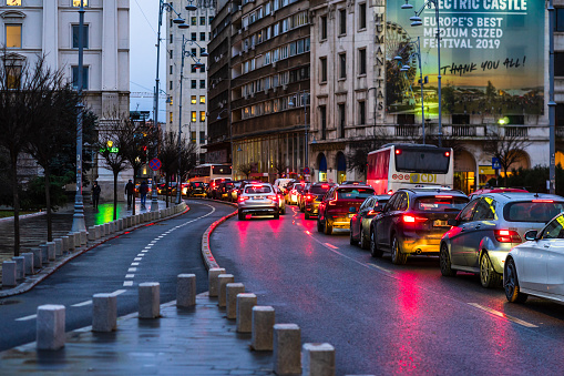 Car traffic at rush hour on the main boulevard in Bucharest downtown. Rainy morning, rainy evening during winter in Bucharest, Romania, 2020
