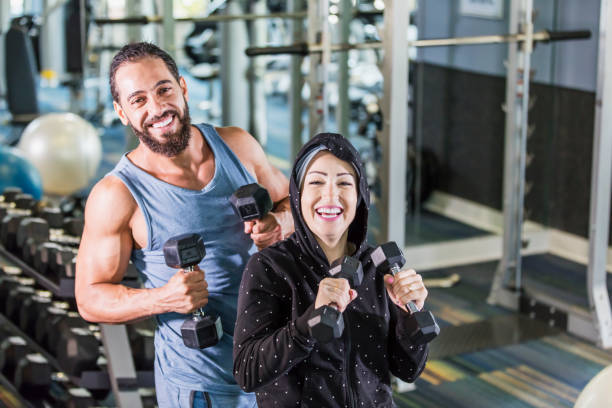istock Middle Eastern couple exercising at the gym 1204279123