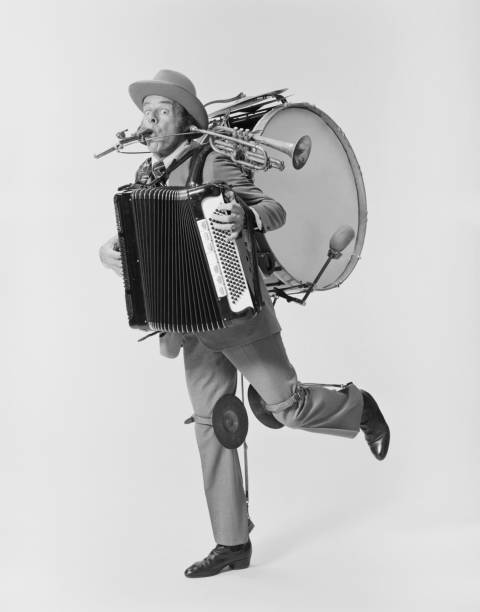 hombre maduro tocando una gran variedad de instrumentos musicales en blanco backg - historical person fotografías e imágenes de stock