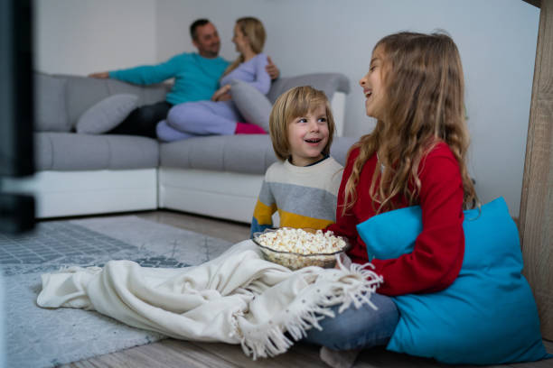istock Family watching TV 1204280093