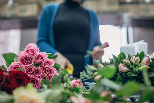 Woman arranging flower decoration for wedding.