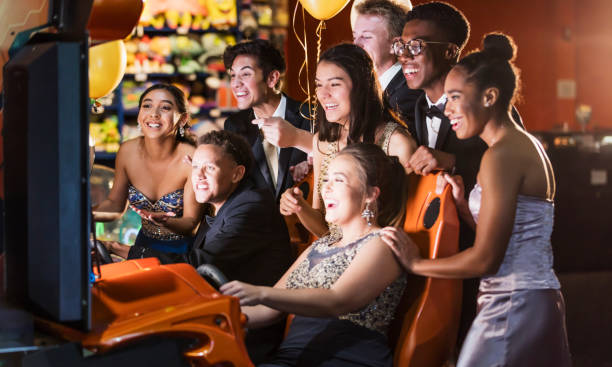 istock Teenagers after prom at video arcade 1204280932