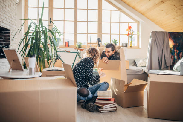 istock Happy couple moving in into new home 1204282154
