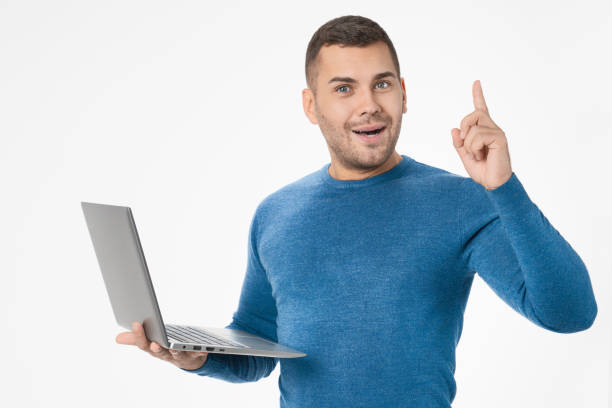 istock Young man with laptop and raised finger with idea on white background 1204282973