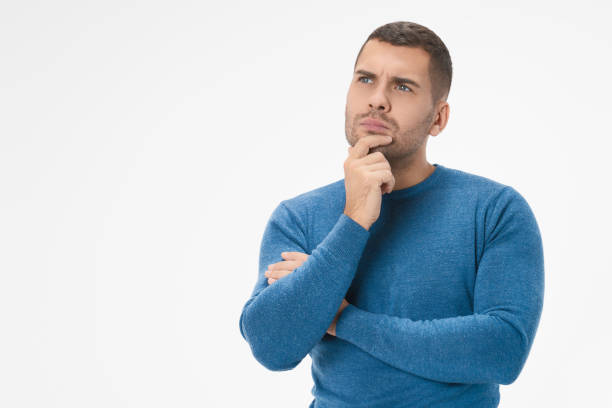 istock Portrait of handsome young man thinking on something isolated on white background 1204282983
