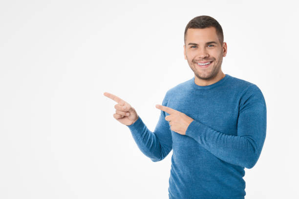 istock Caucasian man pointing with fingers and looking at camera isolated on white background 1204283065