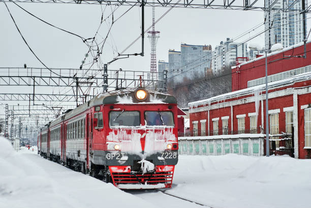 Perm, Russia - February 01, 2020: ice covered passenger electric multiple-unit train at winter railway junction \