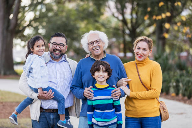 istock Three generation Hispanic family taking walk in park 1204283337