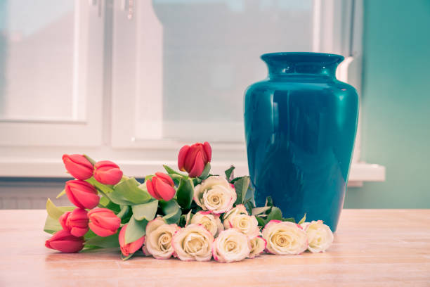 Bunch of Red Tulips and White Roses with Blue Vase on Table