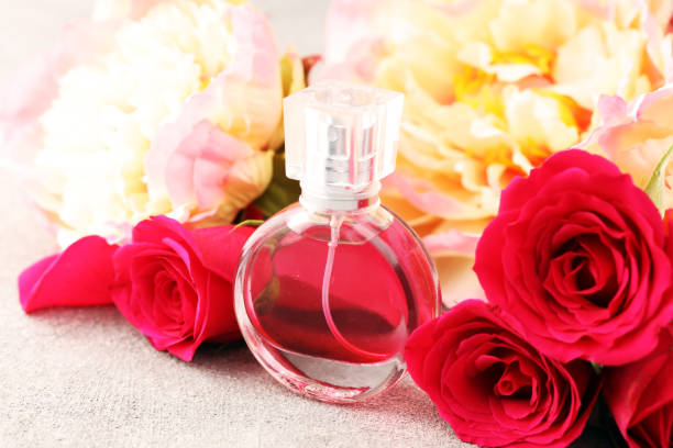 istock Bottle of perfume with flowers on rustic background. Aroma scent wellness concept 1204284480