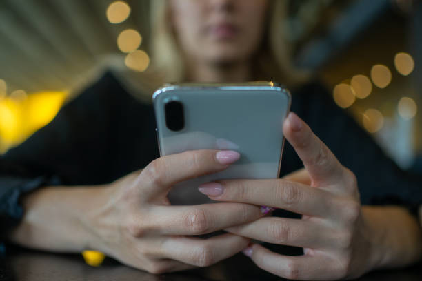 istock Woman using mobil phone in cafe 1204284723