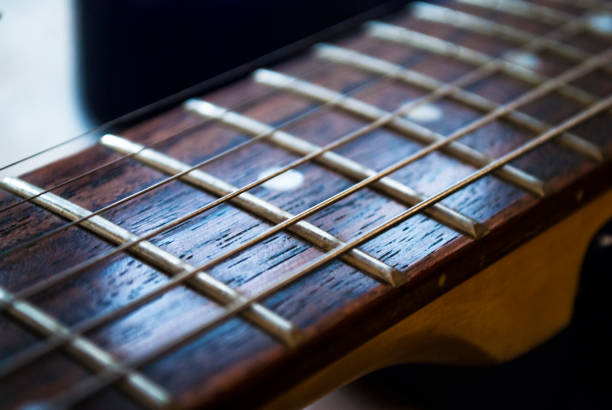 istock Guitar strings on a wooden neck closeup. 1204286009