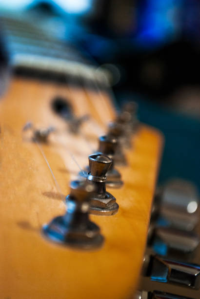 istock Guitar strings on a wooden neck closeup. 1204286011