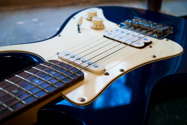 istock Blue-white electric guitar close-up. The strings. 1204286014