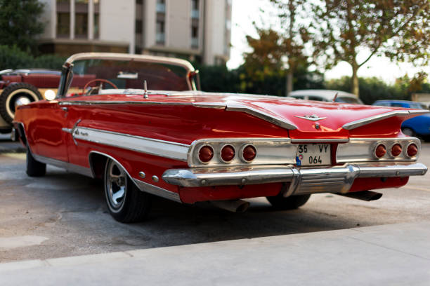 Izmir, Turkey - September 23, 2018: Rear view of a red colored 1960 Chevrolet Impala parked.