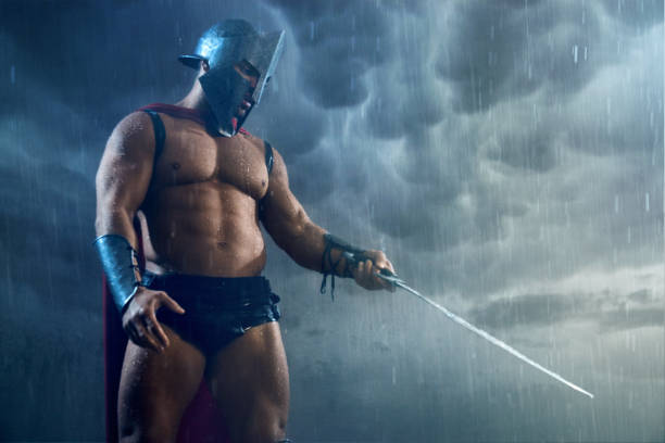 istock Muscular spartan pointing sword. 1204288252