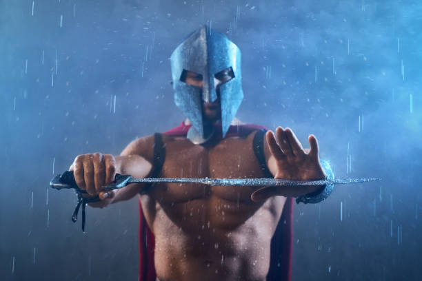 istock Sword with raindrops in hands of spartan. 1204288261