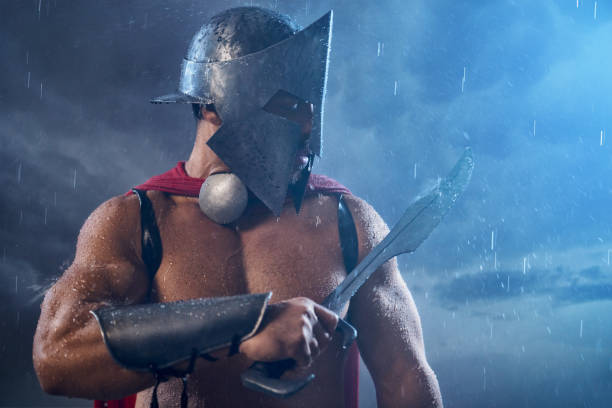 istock Muscular spartan looking at blade. 1204288273