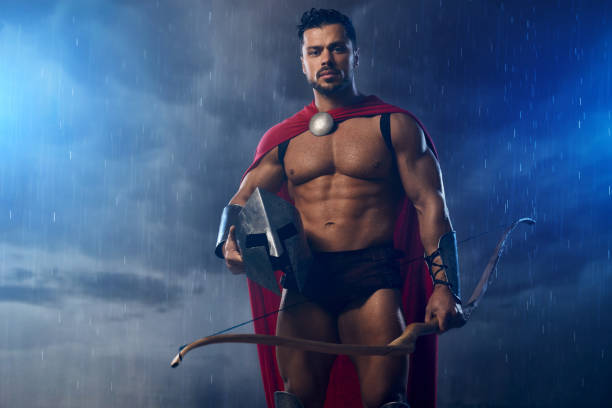 istock Muscular wet spartan archer holding helmet. 1204288463