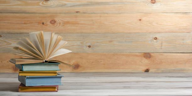 istock Open book, hardback books on wooden table. Back to school. Copy space. 1204289535