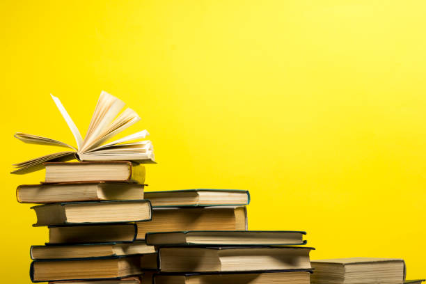 istock Open book, hardback books on wooden table. Back to school. Copy space. 1204289712
