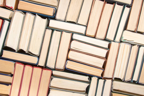 istock Open book, hardback books on wooden table. Back to school. Copy space. 1204290659