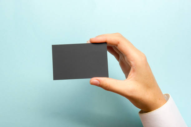istock Hand holding white business card on white background 1204291827