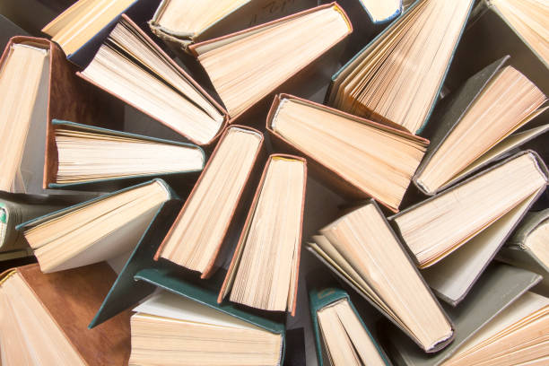 istock Open book, hardback books on wooden table. Back to school. Copy space. 1204291901
