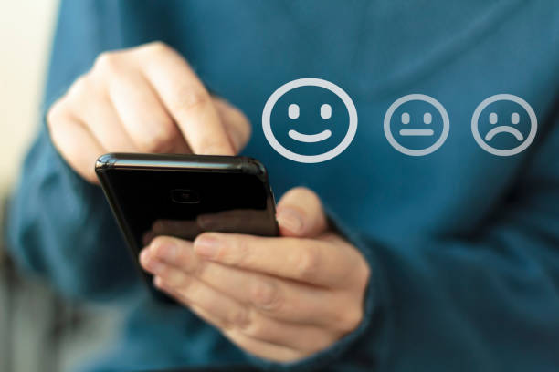 istock Woman using smartphone for service rating and customer satisfaction online 1204291905