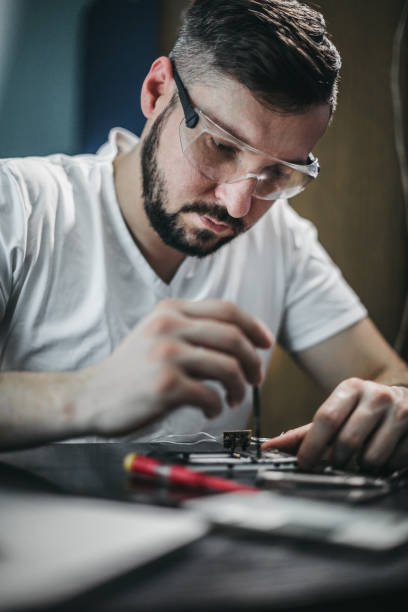 istock Repairman disassemble motherboard with screwdriver 1204293824