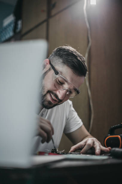 istock Repairman disassemble motherboard with screwdriver 1204294497