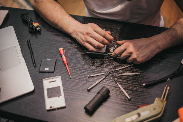 istock Smart phone repairing man with screwdriver 1204294690