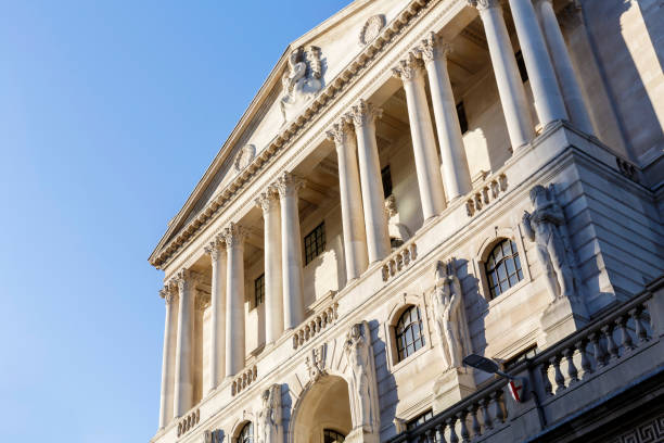 View of the facade of the Bank of England building in the City of London View of the Bank of England and Royal Exchange buildings in the City of London bank of england stock pictures, royalty-free photos & images