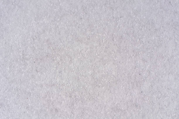 istock Background of fresh snow white natural texture pattern for minimalistic design in grey tone. Top view witn snowflakes and large cereals. Concept of abstract winter surface with copy space for text 1204294921