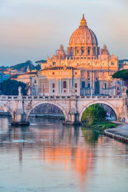 St. Peter's Basilica and Sant'Angelo bridge. Vatican City, Rome, Italy Rome, Italy - February 12, 2018: Sunrise view of St. Peter's Basilica and Sant'Angelo bridge, reflection on Tiber River. Vatican City, Rome, Italy. Shoot from public bridge Umberto I. tiber river stock pictures, royalty-free photos & images