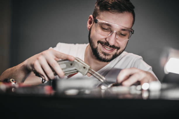 istock Worker solders with a soldering iron 1204295991