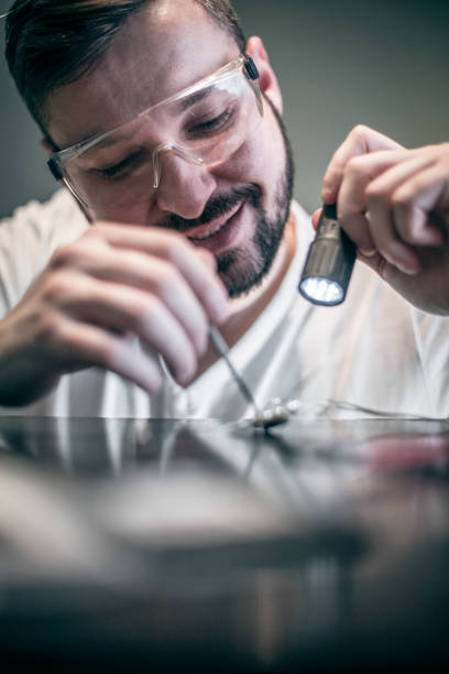 istock Home DIY , worker solders with a soldering iron 1204297985